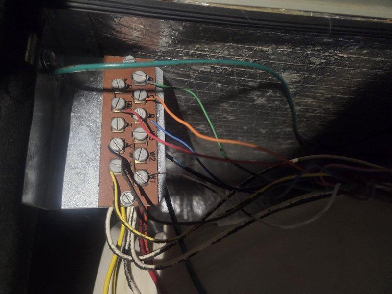 Completed preventive maintenance inspection on two HVAC systems. Accessed equipment through wall-mounted service panel, inspected filter size requirements (20x25x1), and examined electrical terminal connections and wiring at control board. Observed dust and fiber accumulation on ductwork and internal components, indicating normal system operation since last service interval. All electrical connections secure and properly terminated at terminal block with appropriate wire routing. Systems operational and ready for cooling season.