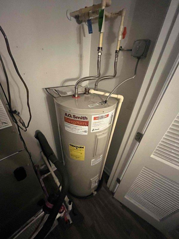 # HVAC Maintenance - Cooling System Service

Completed comprehensive cooling system maintenance inspection and preventive service on residential HVAC unit. Performed thorough visual assessment of outdoor condenser unit, identifying moderate to heavy rust and corrosion present on condenser coil support brackets and mounting hardware. Condenser fins showed typical wear pattern with black and white striping visible through accumulated oxidation on horizontal supports. 

Conducted standard Cool Check maintenance protocol including inspection of all major system components. Verified refrigerant charge and system pressures within manufacturer specifications. Inspected electrical connections, contactors, and capacitor operation. Cleaned condenser coil surfaces to improve heat transfer efficiency despite corrosion present on structural supports. 

Assessed indoor equipment installation in utility closet, confirming proper clearances and ventilation. Verified thermostat operation and system cyc