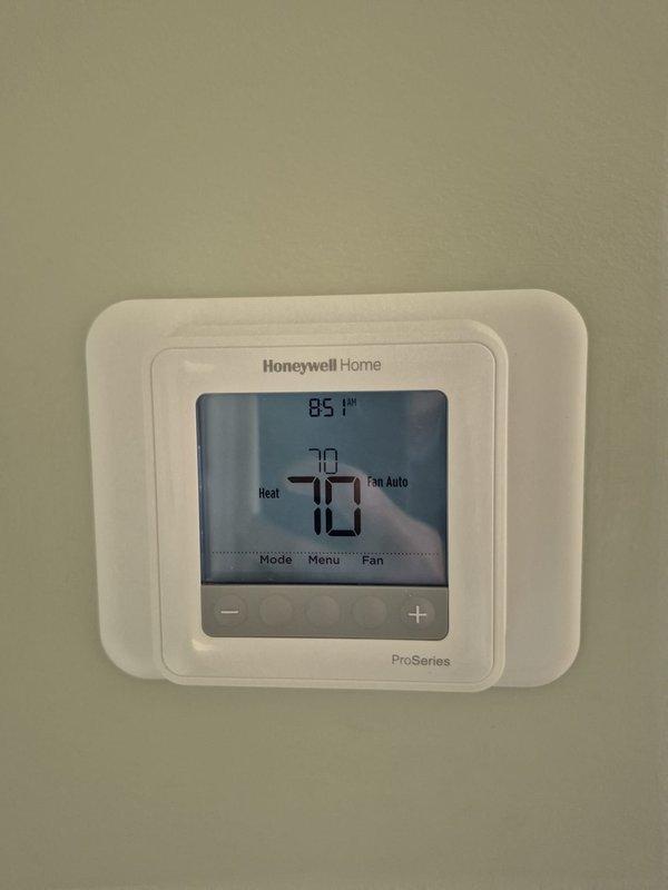 Performed preventative maintenance and leak check on two HVAC systems. Downstairs unit was found to be low on refrigerant; added two pounds of refrigerant and injected UV dye into the system to facilitate leak detection during next scheduled maintenance visit. Both thermostats verified operational with proper temperature control and settings confirmed.