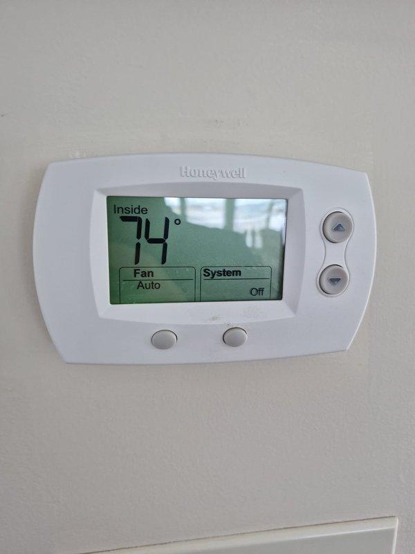 Performed cooling season preventive maintenance inspection on first of two HVAC systems. Verified thermostat operation and confirmed proper temperature display and control settings. System operating within normal parameters with no deficiencies noted at time of service.