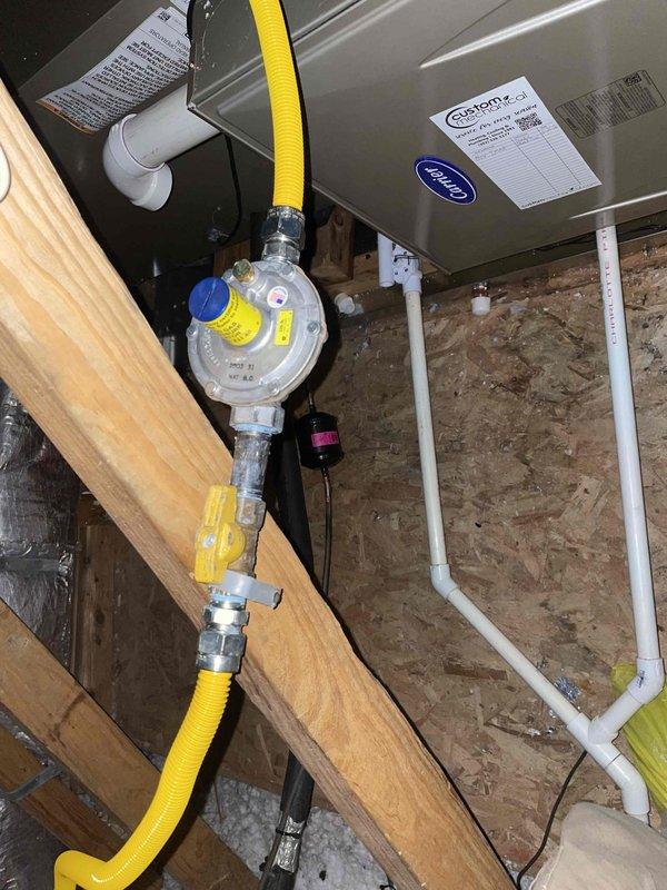 Removed and disposed of existing geothermal equipment and installed complete dual fuel heating and cooling system. Installed Carrier 59SC2E080M21 96% two-stage gas furnace with variable speed blower for natural gas operation in attic space. Mounted Carrier 27SCA542A003 3.5-ton 15 SEER heat pump outdoor unit on pressure-treated wood platform. Installed Carrier CAAMP6121 evaporator coil and fabricated metal duct transitions to adapt new equipment to existing ductwork. Extended refrigerant lineset from basement geothermal cube location through exterior wall to new outdoor unit position. Replaced outdoor disconnect and electrical whip to meet code requirements for new equipment. Reused existing filter rack at unit and provided two 20x20x5 filters with installation. Reused existing electrical service, condensate drain lines, and power connections where applicable. Installed Honeywell digital dual fuel thermostat system with wireless outdoor temperature sensor for optimized heating source se