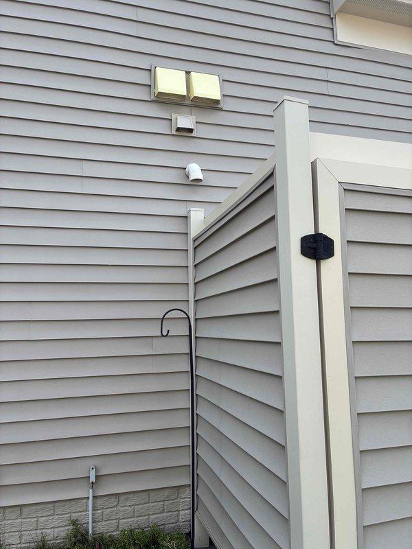 Performed on-site evaluation of existing 13-year-old 65-gallon gas-fired tank water heater located in garage. Inspected unit condition, venting system through exterior wall, copper supply line connections, and gas line configuration. Documented current installation including water treatment device, shut-off valves, and plumbing connections. Provided estimate for complete water heater replacement.
