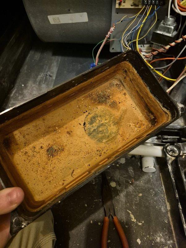 Completed routine cooling maintenance visit on HVAC system. Inspected and removed heavily corroded condensate drain pan showing extensive rust damage and deterioration from prolonged water exposure. Replaced failed drain pan with new component, cleaned and flushed drain line to ensure proper condensate removal. Verified all electrical connections, inspected blower motor assembly, and confirmed system operational status upon completion.