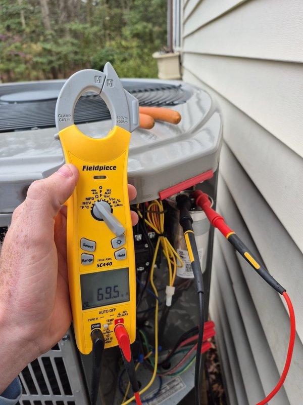 # HVAC Service - No Cool <10 years old

Responded to no cooling complaint on residential air conditioning system. Upon arrival, performed diagnostic electrical measurements on outdoor condensing unit using clamp meter. Tested amperage draw and voltage readings at multiple points within the system with access panel open. Inspected internal electrical components including capacitor, wiring connections, and control circuits. Measured compressor amperage reading of 6.85 amps and system voltage of 744 volts during troubleshooting procedures. Verified proper wire connections on yellow, red, and black conductors throughout electrical circuit. System restored to normal cooling operation following diagnostics and corrective measures.