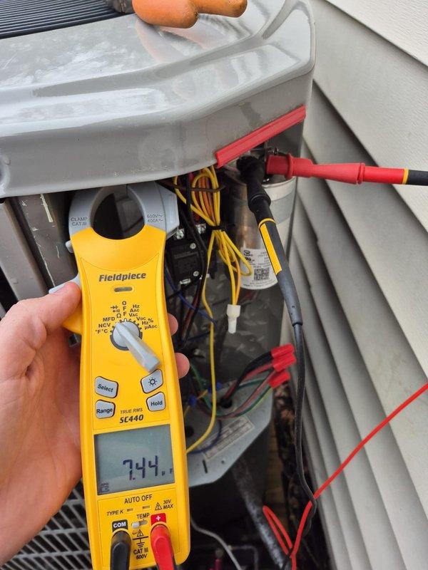 # HVAC Service - No Cool <10 years old

Responded to no cooling complaint on residential air conditioning system. Upon arrival, performed diagnostic electrical measurements on outdoor condensing unit using clamp meter. Tested amperage draw and voltage readings at multiple points within the system with access panel open. Inspected internal electrical components including capacitor, wiring connections, and control circuits. Measured compressor amperage reading of 6.85 amps and system voltage of 744 volts during troubleshooting procedures. Verified proper wire connections on yellow, red, and black conductors throughout electrical circuit. System restored to normal cooling operation following diagnostics and corrective measures.