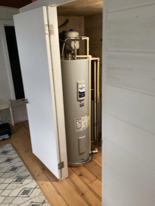 Installed a 50-gallon tall residential electric water heater (model RE250T61) in utility closet with complete plumbing connections. Installation included 22-inch drain pan for leak protection, thermal expansion tank mounted to wall with brass fittings, dual 18-inch flexible water connectors, brass nipples (3/4" x 2" and 3/4" x 6"), high-temperature rated 3/4" male adapters, 3/4" brass 90-degree elbow, and 3/4" brass tee for proper water distribution. Connected copper supply lines and verified all connections for proper operation and leak-free performance.