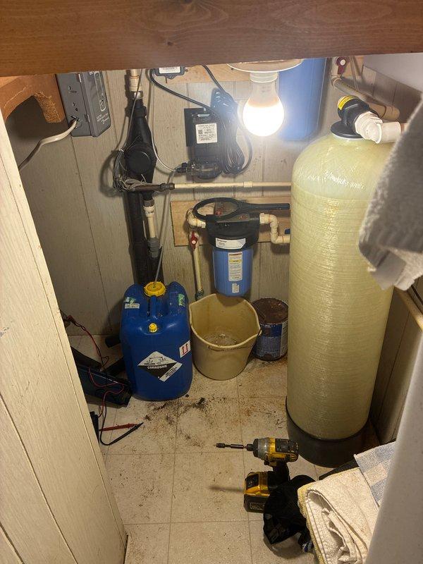 Responded to no hot water complaint on electric water heater. Upon arrival, verified lack of hot water at fixtures and checked electrical panel for tripped breakers. Inspected water heater installation in utility closet, confirmed power supply to unit, and assessed overall plumbing system including water softener and filtration equipment. Photographed equipment configuration and mechanical room setup for service documentation.