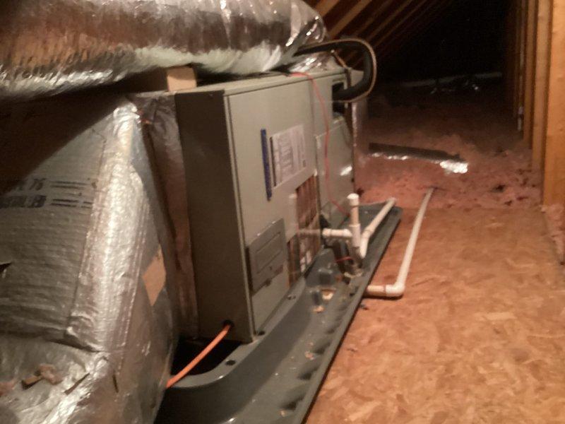 Conducted site evaluation for outdoor unit replacement on dual-zone residential HVAC system. Inspected two existing outdoor condensing units from 2008 installation showing weathered condition but currently operational. Documented existing equipment configuration including attic-mounted air handler with refrigerant lines and condensate drainage, and closet-mounted American Standard air handler with associated ductwork. Photographed current system components to provide accurate replacement estimate for outdoor units while retaining functional indoor equipment.