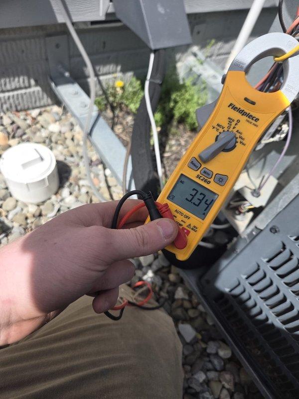 Performed routine cooling system maintenance on outdoor condensing unit. Measured electrical current draw at 33.3 amps and recorded superheat reading of -5.5°F, indicating system is operating within normal parameters.