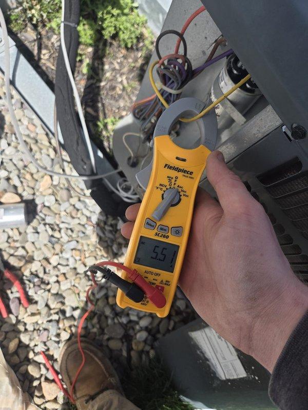 Performed routine cooling system maintenance on outdoor condensing unit. Measured electrical current draw at 33.3 amps and recorded superheat reading of -5.5°F, indicating system is operating within normal parameters.