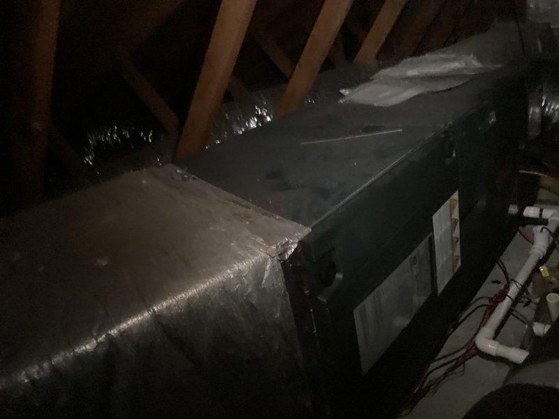 Inspected upstairs HVAC system and identified a refrigerant leak on the outdoor unit coil in a non-repairable section. Accessed attic-mounted air handler and outdoor condensing unit, documented existing equipment condition through photographs, and provided customer with replacement estimate due to the nature and location of the coil failure requiring full system replacement.