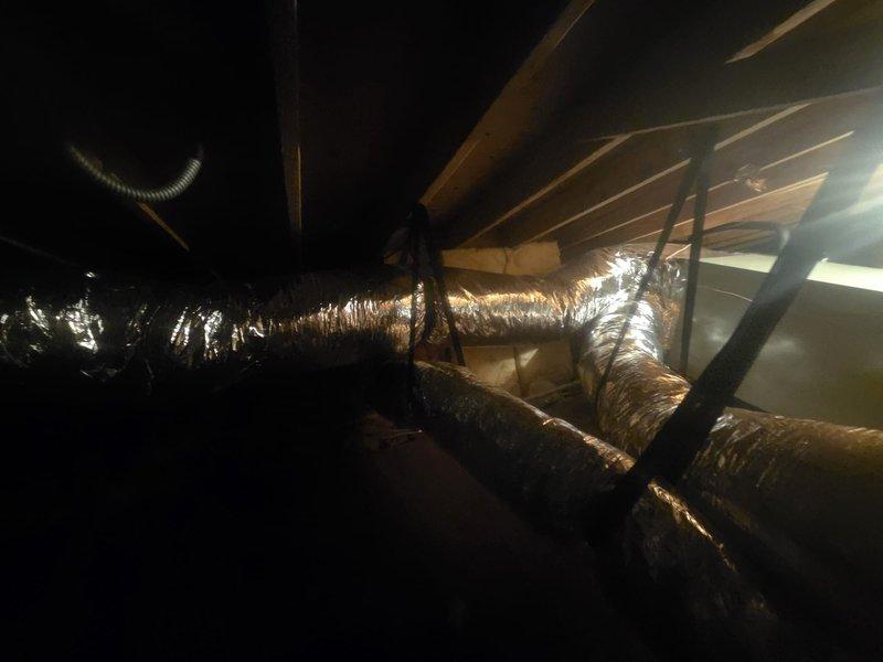 Completed full HVAC system replacement including removal and disposal of existing equipment and outdated ductwork. Installed 5A6V0X48 variable speed heat pump outdoor unit on existing stand with surge disconnect and whip, paired with 5TEMCD06 variable speed communicating fan coil unit mounted in drain pan with shut-off valve. Replaced all refrigeration lines to accommodate new equipment specifications.

Redesigned and installed ductwork system per engineering specifications to support larger capacity system, including new supply plenum and strategic placement of volume dampers for proper airflow balancing. Wrapped existing bedroom-side ductwork with R8 foil-faced insulation for improved thermal efficiency. Upgraded undersized 5-inch supply runs serving two bedrooms and sunroom with larger diameter supplies. Installed new R8 foil-faced flexible supply ducts to existing boots and increased return duct sizing as required for proper system performance.

Added 14x14 flat return air grille i