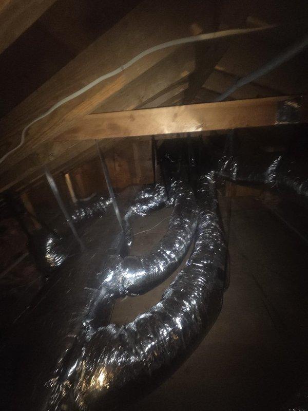 Completed full HVAC system replacement including removal and disposal of existing equipment and outdated ductwork. Installed 5A6V0X48 variable speed heat pump outdoor unit on existing stand with surge disconnect and whip, paired with 5TEMCD06 variable speed communicating fan coil unit mounted in drain pan with shut-off valve. Replaced all refrigeration lines to accommodate new equipment specifications.

Redesigned and installed ductwork system per engineering specifications to support larger capacity system, including new supply plenum and strategic placement of volume dampers for proper airflow balancing. Wrapped existing bedroom-side ductwork with R8 foil-faced insulation for improved thermal efficiency. Upgraded undersized 5-inch supply runs serving two bedrooms and sunroom with larger diameter supplies. Installed new R8 foil-faced flexible supply ducts to existing boots and increased return duct sizing as required for proper system performance.

Added 14x14 flat return air grille i