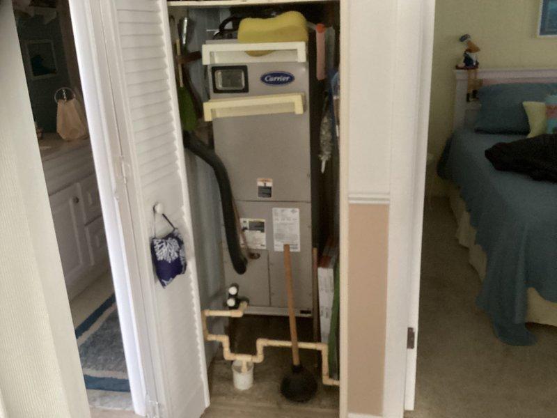 Completed HVAC estimate for replacement of existing Carrier air handler system located in hall closet with outdoor unit in exterior closet. System exhibited significant frost accumulation on refrigerant lines and ductwork, indicating potential refrigerant leak or restriction requiring full system replacement rather than repair.