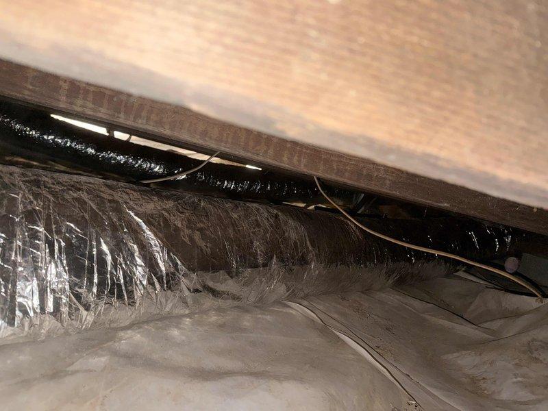 Removed and disposed of existing HVAC equipment from property. Installed American Standard 5WCC4024A1000 2-ton 14 SEER self-contained packaged heat pump unit on existing outdoor stand with American Standard 10kw electric heat pack. Fabricated and installed metal duct transitions to adapt new equipment to existing ductwork infrastructure. Replaced all flexible duct runs from main trunk lines to supply registers throughout conditioned space. Reused existing refrigerant lines and condensate drainage system. Replaced outdoor electrical disconnect and supply whip to meet current code requirements. Installed Honeywell TH6320WF digital WiFi thermostat for system control. Coordinated property access with adjacent property owner to facilitate equipment removal and installation, including temporary fence section removal for unit placement. System tested and verified operational upon completion. One-year parts warranty provided from installation date.