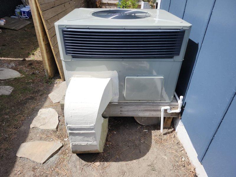 Removed and disposed of existing HVAC equipment from property. Installed American Standard 5WCC4024A1000 2-ton 14 SEER self-contained packaged heat pump unit on existing outdoor stand with American Standard 10kw electric heat pack. Fabricated and installed metal duct transitions to adapt new equipment to existing ductwork infrastructure. Replaced all flexible duct runs from main trunk lines to supply registers throughout conditioned space. Reused existing refrigerant lines and condensate drainage system. Replaced outdoor electrical disconnect and supply whip to meet current code requirements. Installed Honeywell TH6320WF digital WiFi thermostat for system control. Coordinated property access with adjacent property owner to facilitate equipment removal and installation, including temporary fence section removal for unit placement. System tested and verified operational upon completion. One-year parts warranty provided from installation date.