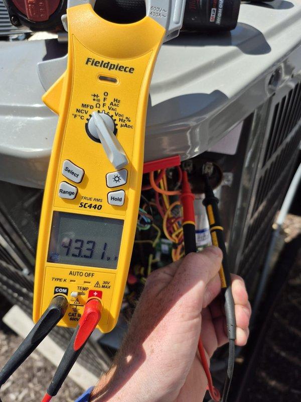 Completed preventive maintenance on cooling system. Verified thermostat operation showing indoor temperature at 74°F with 34% humidity and confirmed proper system scheduling in heat mode. Measured electrical parameters using clamp meter, recording 133.1 amp reading at outdoor unit, and inspected all electrical connections and wiring for proper operation.