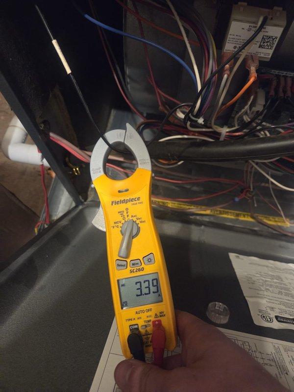Completed routine cooling maintenance visit on HVAC system. Performed electrical diagnostics using clamp meter, recording amperage readings of 339A and 0.58A on various circuits to verify proper system operation and component function. Inspected electrical connections, wiring bundles, and condensate pump assembly. All measurements within normal operating parameters, system operating as designed.