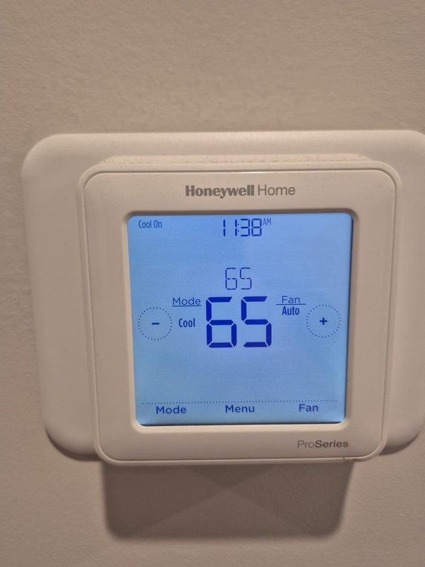 Performed cooling system maintenance and verification. Measured evaporator coil temperature at 65°F and confirmed thermostat operation with system actively cooling to setpoint of 65°F in auto fan mode.