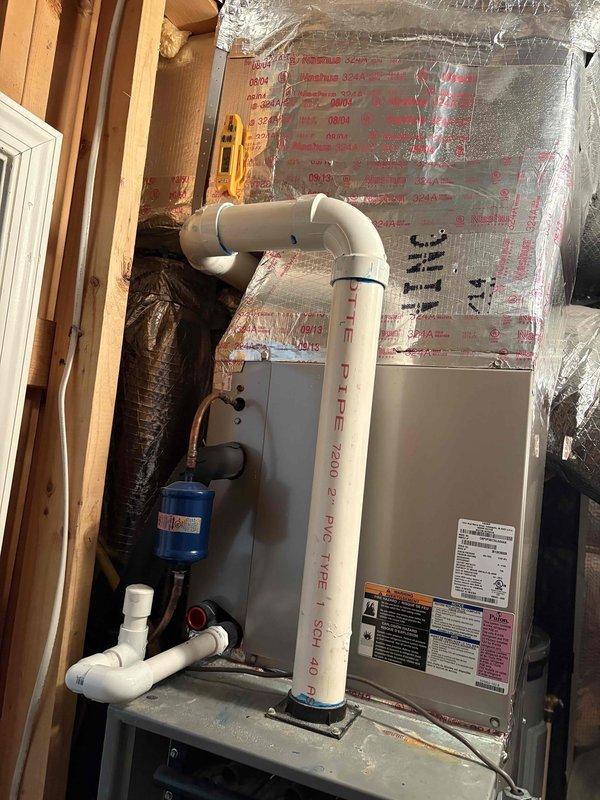 Responded to no cooling complaint on residential HVAC system. Upon arrival, accessed vertical furnace unit in attic space and inspected air handler with front panel removed. Evaluated internal components including wiring, circuit boards, and mechanical parts. Examined refrigerant system connections and blue filter drier component mounted to air handler. Verified PVC condensate drainage system and flexible ductwork connections. Documented equipment condition with photographs showing system configuration and component accessibility. System appears to be less than 10 years old based on equipment condition and labeling.