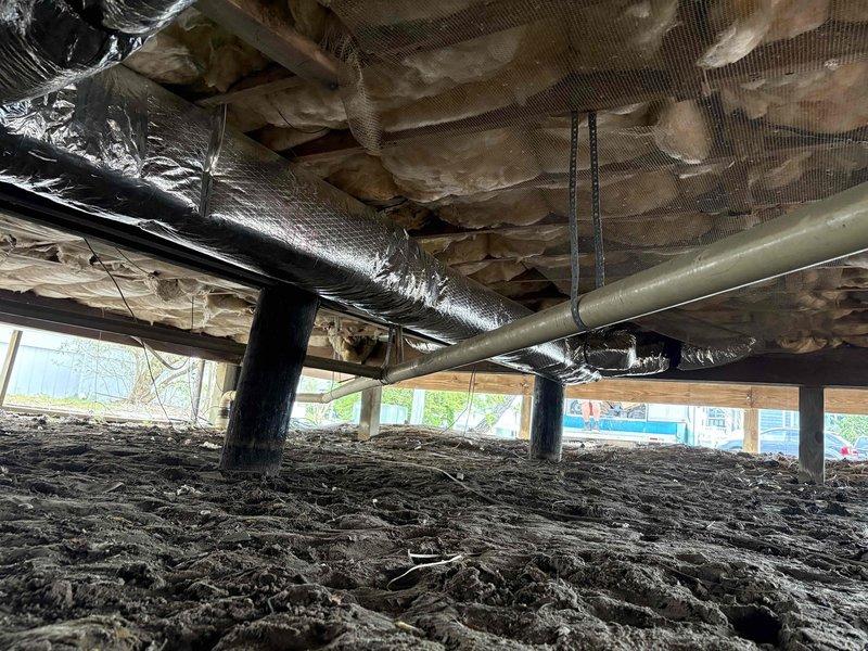 Completed full ductwork system replacement in crawlspace. Removed and disposed of deteriorated fiberglass trunk duct and damaged flexible run outs that showed significant wear and compromised insulation integrity. Installed new insulated metal trunk duct system with flexible run outs throughout crawlspace, incorporating balancing dampers at strategic locations to optimize airflow distribution. Sealed all duct connections with mastic and hard cast tape to ensure proper air sealing and system efficiency. Reused existing floor boots and registers in good condition. All ductwork properly secured to floor joists with appropriate hangers and strapping to prevent sagging and maintain proper pitch for condensate drainage.