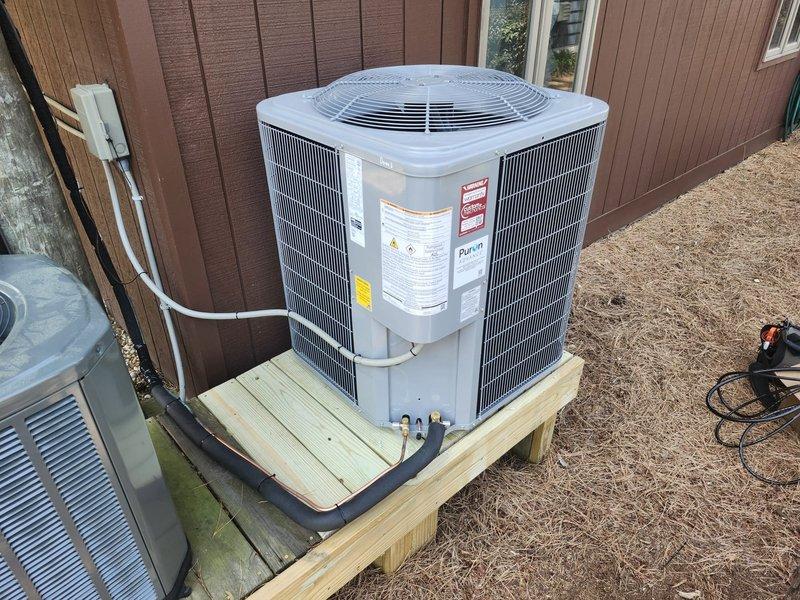 Completed full HVAC system replacement including removal and disposal of existing equipment. Installed new Carrier 27SCA530A003 2.5-ton 15 SEER heat pump outdoor unit on pressure-treated wood platform. Installed Carrier FJ5ANXB30L00 air handler with Carrier FF-2601C10 10kW electric heat pack. Fabricated and installed metal duct transitions to adapt new equipment to existing ductwork. Reused existing refrigerant lines and condensate drain. Replaced outdoor electrical disconnect and whip to meet current code requirements. Installed Honeywell TH6320WF digital WiFi thermostat for system control. Verified proper system operation, refrigerant charge, and airflow upon startup.