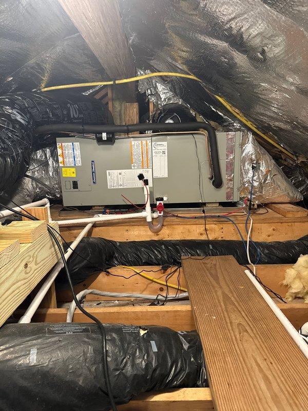 Removed and disposed of existing attic air handler unit. Installed new 2-ton 17 SEER heat pump system including 5A6H7024 outdoor unit mounted on existing stand with privacy screening, 5TEM6B02 variable speed air handler with drain pan and shutoff valve mounted horizontally in attic space, and 10KW electric heat strip with breaker. Installed TH6320WF WiFi thermostat and 1-inch filter rack. Ran and secured black flexible ductwork throughout attic space connecting to new air handler. Flushed existing refrigeration lines, performed pressure test to verify system integrity, and recharged system to manufacturer specifications. Verified all electrical connections, tested system operation in heating and cooling modes, and confirmed WiFi thermostat connectivity and programming.