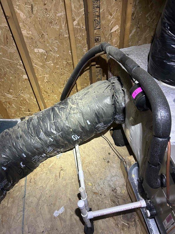 Responded to no-cool service call on residential HVAC system in unfinished construction space. Upon arrival, performed diagnostic inspection of system components including ductwork, refrigerant lines, and electrical connections. Customer suspected failed capacitor, however thorough evaluation of unit required accessing equipment in area with exposed framing and OSB subflooring. Documented system configuration with photos showing flexible ductwork installation and insulated refrigerant line routing through construction space. Completed necessary repairs to restore cooling operation.