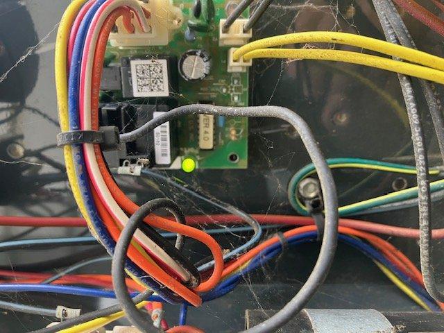 Responded to no cooling call on residential air conditioning system. Upon arrival, accessed unit located under back porch and air handler in separate basement room. Performed diagnostic evaluation and confirmed compressor failure to engage. Inspected control board, wiring connections, and electrical components within system. Documented equipment condition with photos showing control board assembly and outdoor unit installation. System requires compressor replacement or full outdoor unit replacement due to age of equipment exceeding 10 years.