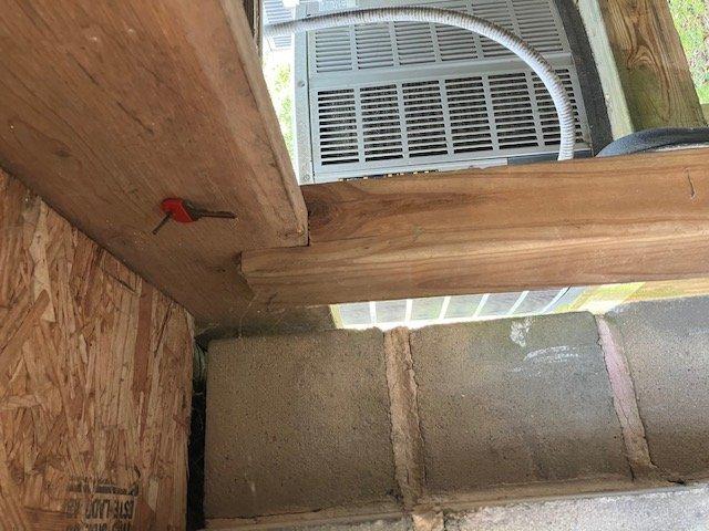 Responded to no cooling call on residential air conditioning system. Upon arrival, accessed unit located under back porch and air handler in separate basement room. Performed diagnostic evaluation and confirmed compressor failure to engage. Inspected control board, wiring connections, and electrical components within system. Documented equipment condition with photos showing control board assembly and outdoor unit installation. System requires compressor replacement or full outdoor unit replacement due to age of equipment exceeding 10 years.