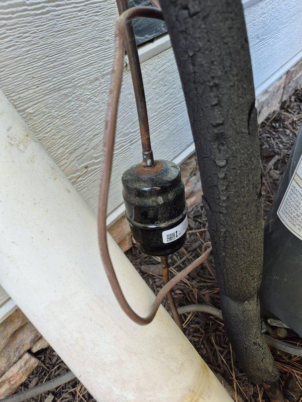 Responded to no cooling complaint on residential HVAC system. Upon arrival, found thermostat calling for cooling with indoor temperature at 75°F and setpoint at 74°F, but system not maintaining desired temperature. Inspected outdoor unit and identified worn compressor hard start capacitor with visible corrosion on refrigerant line connections. Replaced failed hard start component and verified proper compressor operation. System restored to normal cooling operation with satisfactory temperature differential.