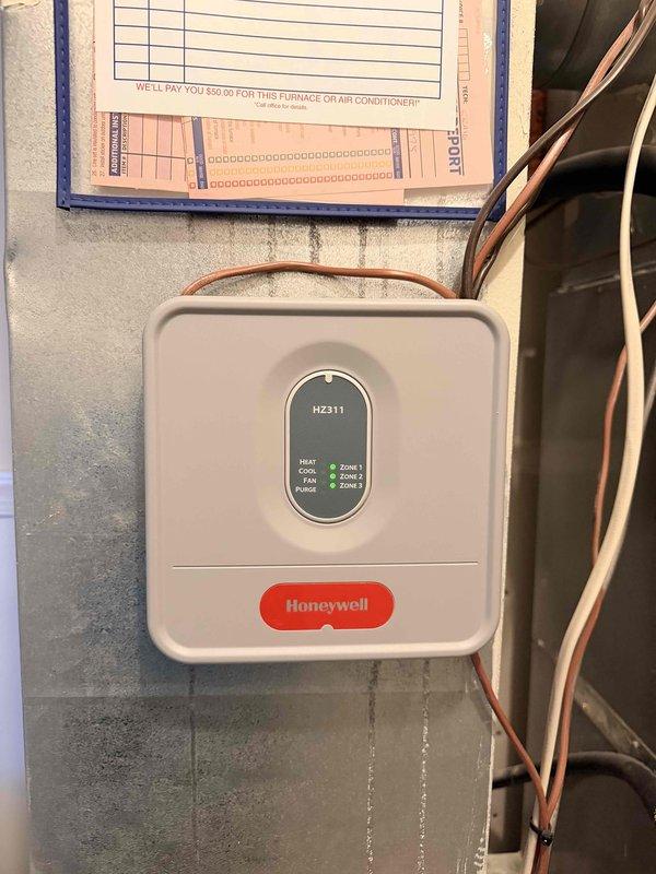 Conducted replacement estimate for HVAC system in two-story townhouse. Evaluated existing equipment located on second floor in closet adjacent to bathroom, including multi-zone Honeywell HZ311 control panel with three-zone configuration. Documented current system components, zone controls, and installation configuration to provide comprehensive replacement recommendations.