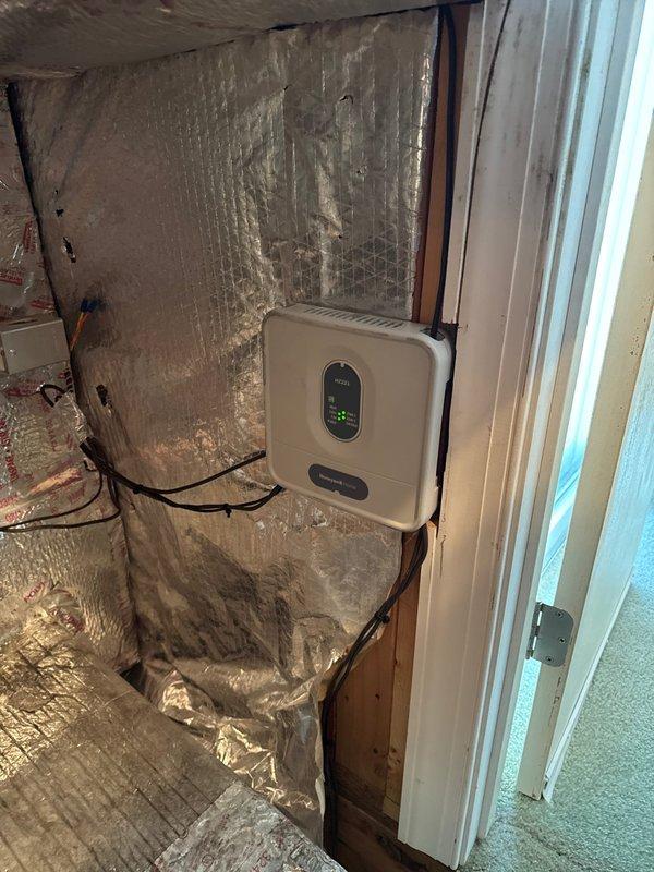 Removed and disposed of existing HVAC equipment from basement utility space. Installed new Lennox ML14KP1-024 2-ton 14 SEER heat pump system with Lennox CBK45UHET-024 air handler and 10 kW electric heat pack in attic space. Fabricated and installed metal duct transitions to adapt new equipment to existing ductwork system. Mounted air handler on plywood platform with proper support and secured all ductwork connections with reflective foil-faced insulation for thermal efficiency.

Installed Honeywell standard two-zone zone board to enable multi-zone climate control throughout the home. Reused existing thermostats and integrated them with new zone control system. Replaced outdoor electrical disconnect and whip to meet current code requirements for new heat pump unit. Positioned outdoor heat pump unit on pressure-treated wood platform to ensure proper drainage and equipment longevity.

Reused existing refrigerant lines, condensate drain lines, and power supply connections where applicable 