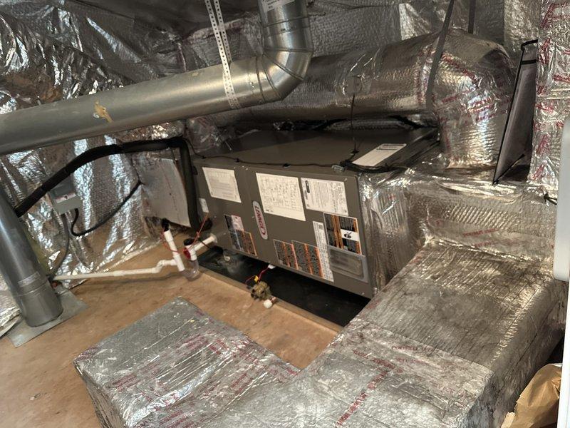 Removed and disposed of existing HVAC equipment from basement utility space. Installed new Lennox ML14KP1-024 2-ton 14 SEER heat pump system with Lennox CBK45UHET-024 air handler and 10 kW electric heat pack in attic space. Fabricated and installed metal duct transitions to adapt new equipment to existing ductwork system. Mounted air handler on plywood platform with proper support and secured all ductwork connections with reflective foil-faced insulation for thermal efficiency.

Installed Honeywell standard two-zone zone board to enable multi-zone climate control throughout the home. Reused existing thermostats and integrated them with new zone control system. Replaced outdoor electrical disconnect and whip to meet current code requirements for new heat pump unit. Positioned outdoor heat pump unit on pressure-treated wood platform to ensure proper drainage and equipment longevity.

Reused existing refrigerant lines, condensate drain lines, and power supply connections where applicable 