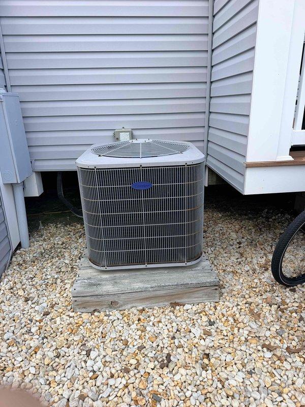 Conducted estimate for HVAC system replacement at townhouse property with 2014 Carrier condensing unit experiencing reduced efficiency. Documented existing outdoor condenser unit in clean condition with proper installation on wooden platform base, though system performance has declined over time. Evaluated electrical disconnect panel showing significant rust corrosion on mounting surface and breaker enclosures, with visible deterioration around circuit breakers including A/C circuit, indicating potential electrical concerns requiring attention during replacement. Provided comprehensive assessment and replacement options to restore system efficiency and address aging equipment concerns.