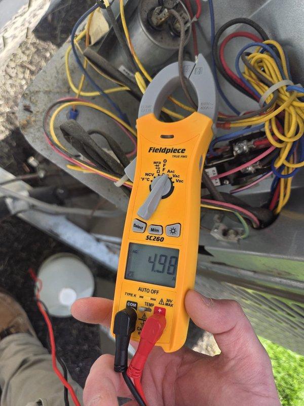 Performed comprehensive cooling system inspection and maintenance on HVAC unit. Conducted operational diagnostics using digital thermometer and clamp meter, measuring system temperatures and electrical parameters to verify proper performance. Return air temperature recorded at 61.8°F, with electrical readings at 498 on the multimeter indicating normal amperage draw. Inspected all electrical connections, wiring, and blower assembly within the air handler unit. Additionally, performed tankless water heater maintenance including system flush to remove mineral buildup and ensure optimal efficiency.