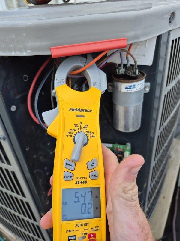 Completed routine cooling system maintenance visit. Verified thermostat operation and calibration, with unit displaying proper temperature readings and system controls functioning correctly. Performed electrical diagnostics using clamp meter to measure amperage draw and system performance, confirming all electrical components including capacitor are operating within manufacturer specifications.