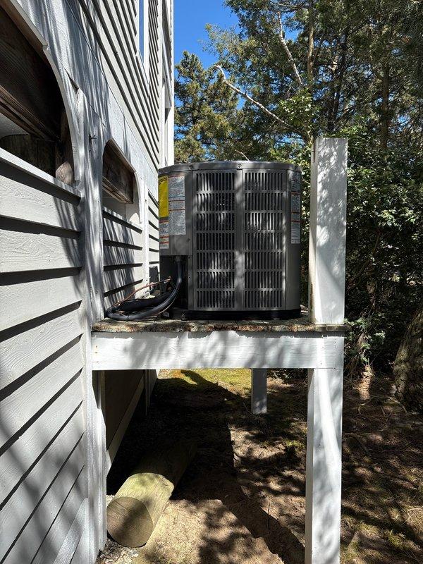 Completed full HVAC system replacement involving removal and disposal of existing equipment. Installed American Standard 5A6H4018A1000 1.5-ton 14 SEER heat pump with matching 5TEM4B02CAC21 air handler, BAYHTR1510 10kw electric heat pack, BAYSF1185 18.5" filter rack, and Honeywell digital thermostat. Fabricated and installed metal duct transitions to adapt new equipment to existing ductwork. Reused existing condensate drain lines while replacing outdoor disconnect and electrical whip to current code standards. Positioned outdoor condensing unit on existing elevated wooden platform alongside previously installed system. All refrigerant lines properly connected and tested for leaks. System commissioned, tested for proper operation, and left in full working order.