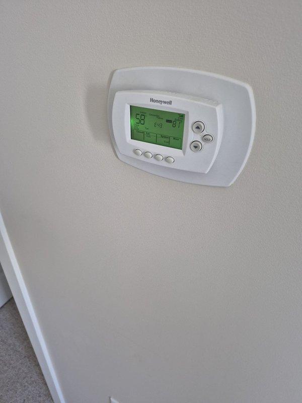 Responded to no heat call for multi-zone system with WiFi thermostats. Found lower zone thermostat not communicating with remote access system. Verified thermostat operation showing 57-59°F indoor temperature, confirmed power and display functioning properly, and troubleshot network connectivity issue preventing remote monitoring of bottom zone on 4-zone, 2-system configuration.