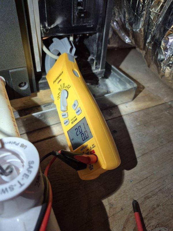 Performed routine cooling system maintenance and inspection. Verified electrical measurements at the outdoor unit, recording compressor amperage at 20.2 amps and confirming proper voltage at 6.19 volts across control circuits. All electrical connections inspected and found secure with no abnormalities detected in the condenser unit's electrical panel or wiring.