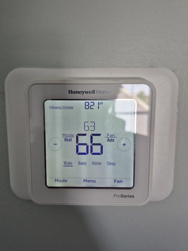 Completed preventive maintenance cooling visit on residential HVAC system. Verified thermostat operation showing proper temperature control and programming functionality, confirmed 24-volt control circuit voltage at outdoor unit measuring 24.5 volts, and inspected all electrical connections and wiring terminals for secure contact and proper operation.