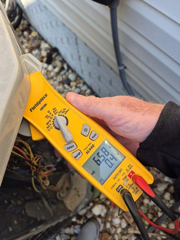 Performed preventative maintenance cooling system inspection on residential HVAC unit. Conducted electrical diagnostics using digital multimeter to verify proper voltage and system operation at outdoor condensing unit. Measured amperage draw on compressor circuit using clamp meter, recording 98.7 amps, and verified all electrical connections within control panel were secure and functioning within manufacturer specifications.