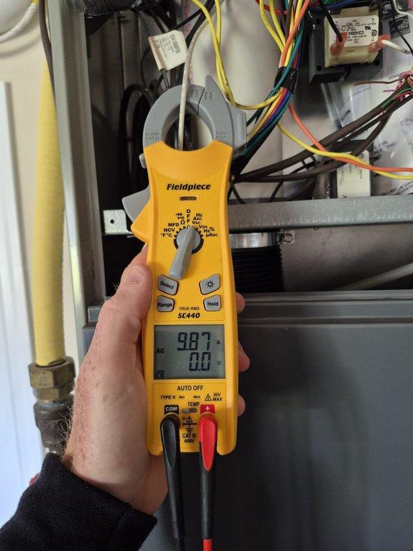 Performed preventative maintenance cooling system inspection on residential HVAC unit. Conducted electrical diagnostics using digital multimeter to verify proper voltage and system operation at outdoor condensing unit. Measured amperage draw on compressor circuit using clamp meter, recording 98.7 amps, and verified all electrical connections within control panel were secure and functioning within manufacturer specifications.
