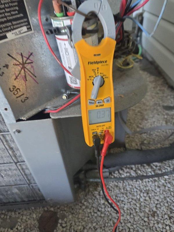Performed cooling system preventative maintenance inspection on outdoor cylindrical condenser unit. Used clamp meter to verify electrical current draw and system amperage, confirming proper operation of compressor and fan motor. All electrical connections tested and found within normal operating parameters.