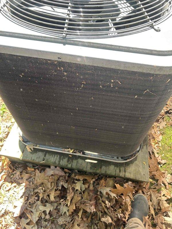 Completed routine cooling maintenance visit on outdoor condenser unit. Unit exterior screening was heavily soiled with accumulated debris, dried leaves, and organic matter affecting airflow efficiency. Cleaned condenser coils and exterior surfaces, removed debris from fan guard and surrounding area, and verified proper system operation upon completion.