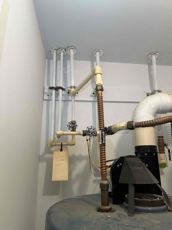 Completed platinum membership maintenance service on two heating systems as contracted. Performed comprehensive inspection and maintenance on dual heating units, including a water heater system and LAARS boiler equipment. Inspected all piping connections, PVC routing, and corrugated flexible ducting for proper installation and functionality. Verified operation of multiple zone valves with black handles throughout the hydronic heating system. Checked all mounting brackets, fasteners, and support systems for secure installation. Examined copper fittings and composite pipe connections for signs of leaks or deterioration. Assessed condition of circulation pump and associated mechanical components on the boiler system. Both heating systems were operational at time of service and maintained proper functionality throughout inspection.
