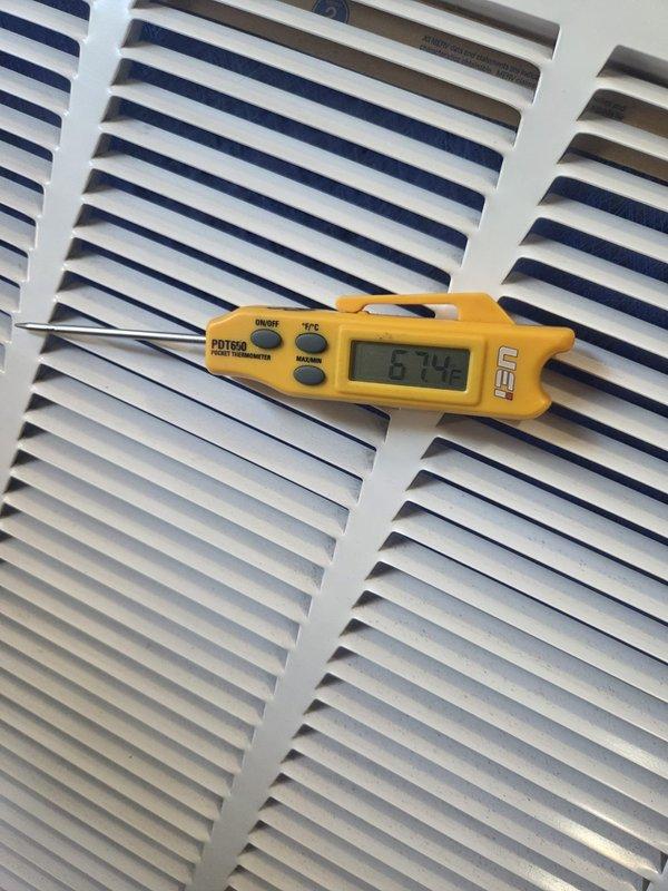 Performed cooling system maintenance and diagnostics on outdoor condensing unit. Measured electrical current draw at 5.03 amps using clamp meter on compressor circuit and verified dual-run capacitor connections. Checked supply air temperature at indoor unit, recording 67°F at the register. All electrical connections, wiring, and capacitor tested within normal operating parameters. System operating efficiently with no service concerns identified.