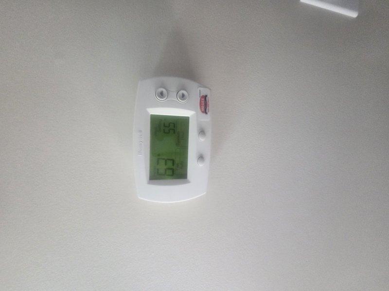 Performed routine HVAC maintenance and cooling system inspection. Accessed thermostat wiring to verify proper connections of all low-voltage control wires at terminal block, confirmed Honeywell digital thermostat displaying accurate temperature readings and responding appropriately to user inputs. System operational and ready for cooling season.