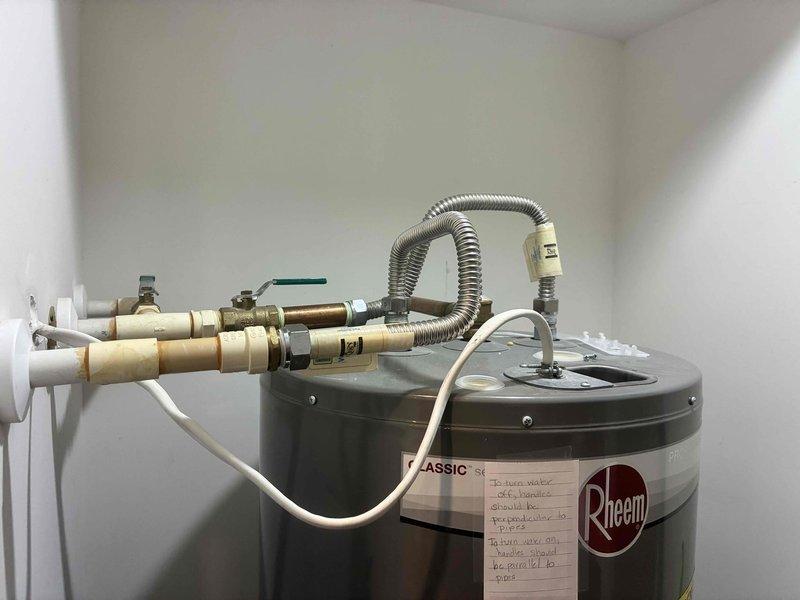 Responded to customer complaint of insufficient hot water from Rheem tanked water heater. Conducted comprehensive inspection of unit and all associated plumbing connections, including pressure relief valve, supply lines, and discharge tube. Evaluated water heater performance, verified proper operation of heating elements and thermostat settings. Assessed installation clearances in utility closet, confirming adequate space for maintenance access. All connections, valves, and safety components found to be properly installed and functioning. Documented existing installation with detailed photographs showing unit specifications, dimensions, and surrounding clearances.