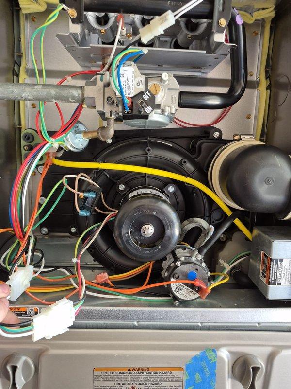 Replaced defective inducer motor and capacitor on Carrier furnace model 59SC2D060E171114 located in garage. Unit was experiencing inducer failure preventing proper operation. Ordered and installed new inducer assembly with capacitor under warranty coverage, verified proper operation, and returned failed inducer motor to counter per warranty requirements.